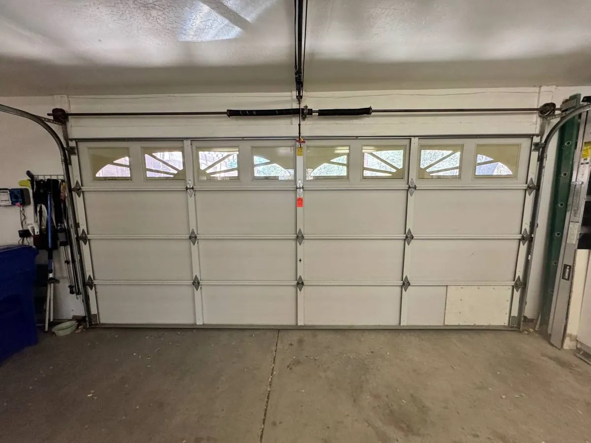 Two-car garage door with decorative windows, completed installation by Ferch Doors LLC